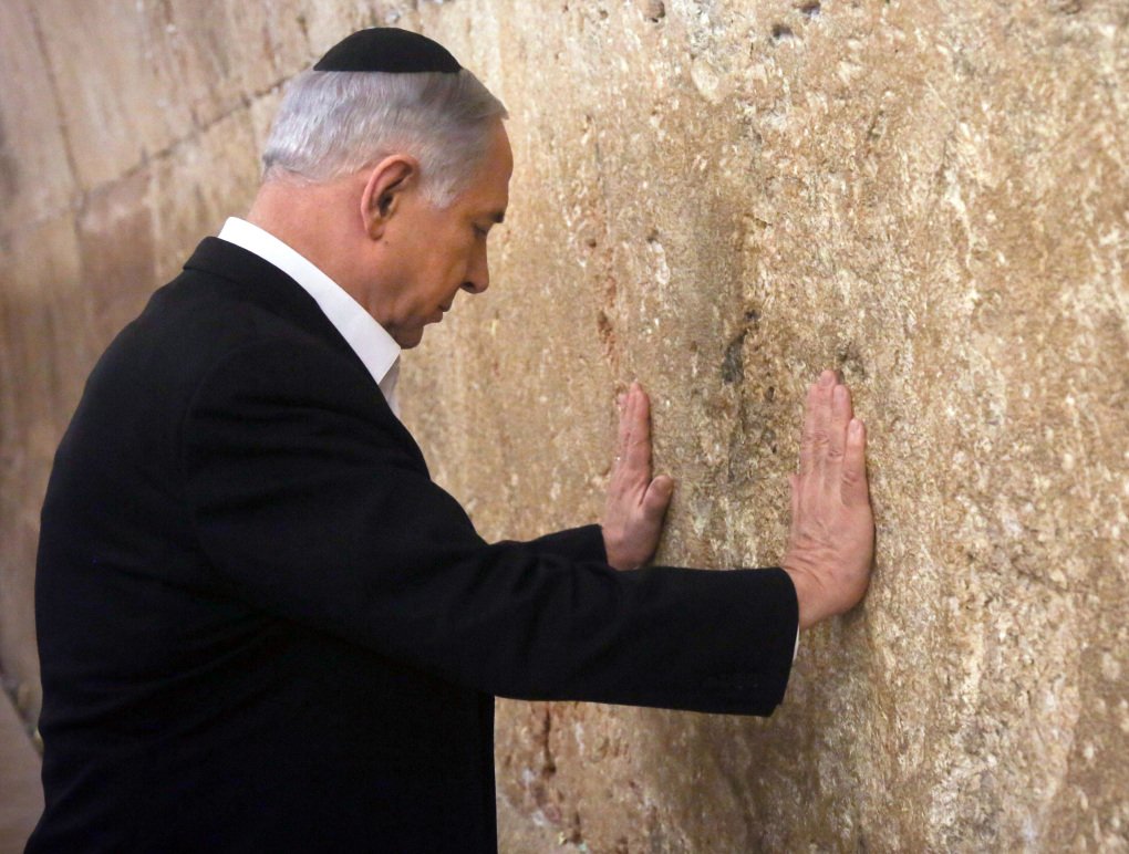 Israeli Prime Minister Benjamin Netanyahu prays at the Western Wall, the holiest site where Jews can pray, in Jerusalem's Old City, Saturday Feb. 28, 2015. (AP Photo/Marc Sellem, Pool)